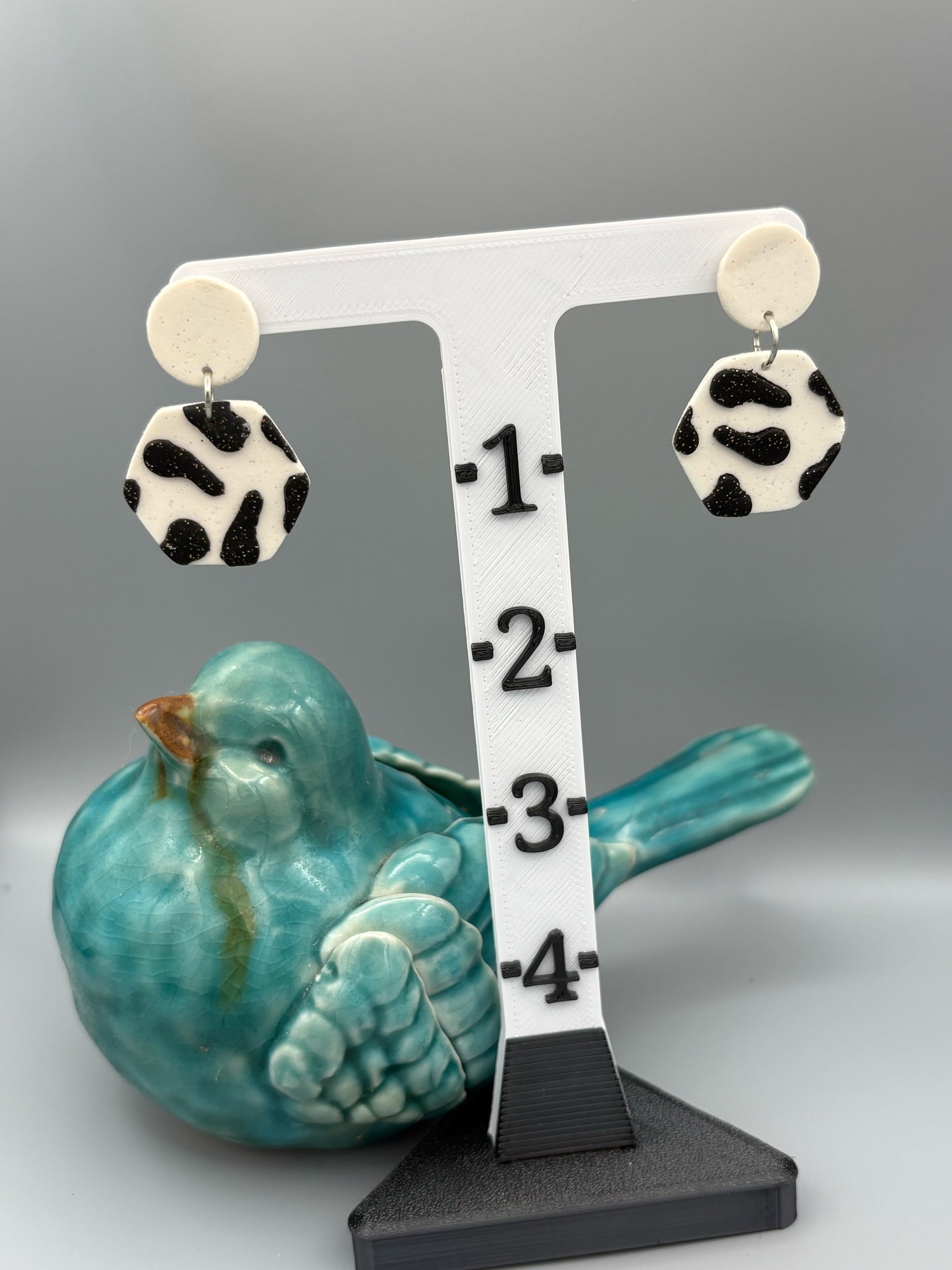 Black Cow Print Hexagon Dangle Earrings - handcrafted polymer clay earrings by Lakeside Clay