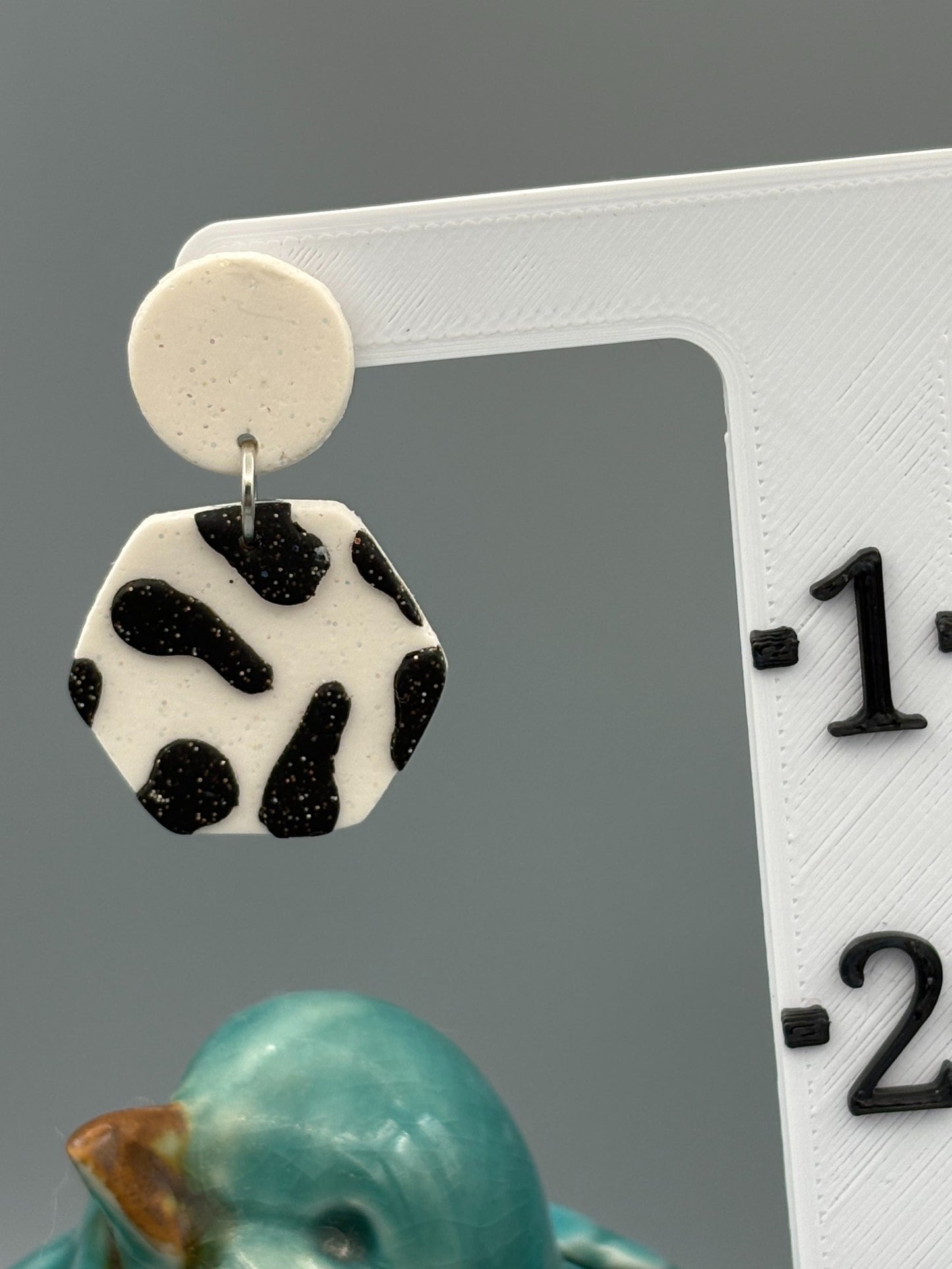 Black Cow Print Hexagon Dangle Earrings - handcrafted polymer clay earrings by Lakeside Clay