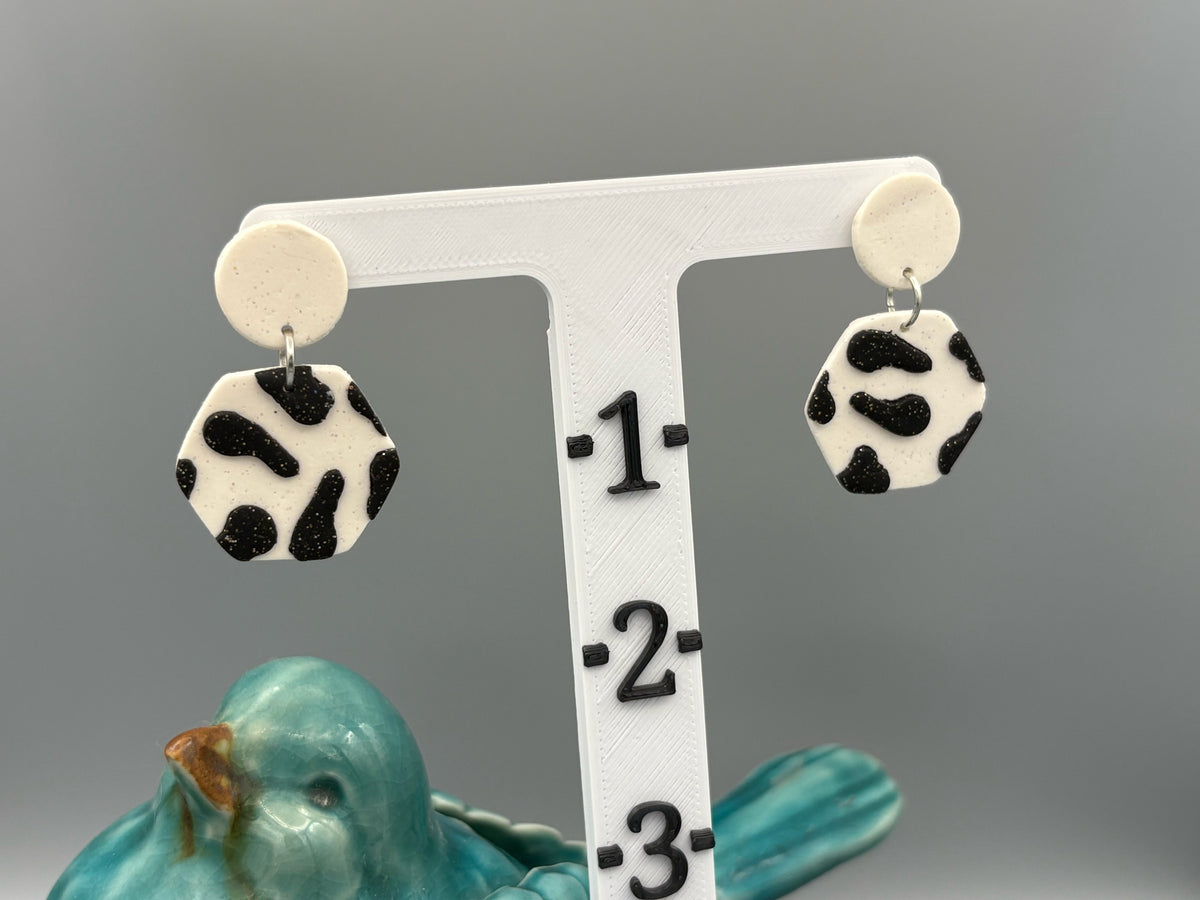 Black Cow Print Hexagon Dangle Earrings - handcrafted polymer clay earrings by Lakeside Clay