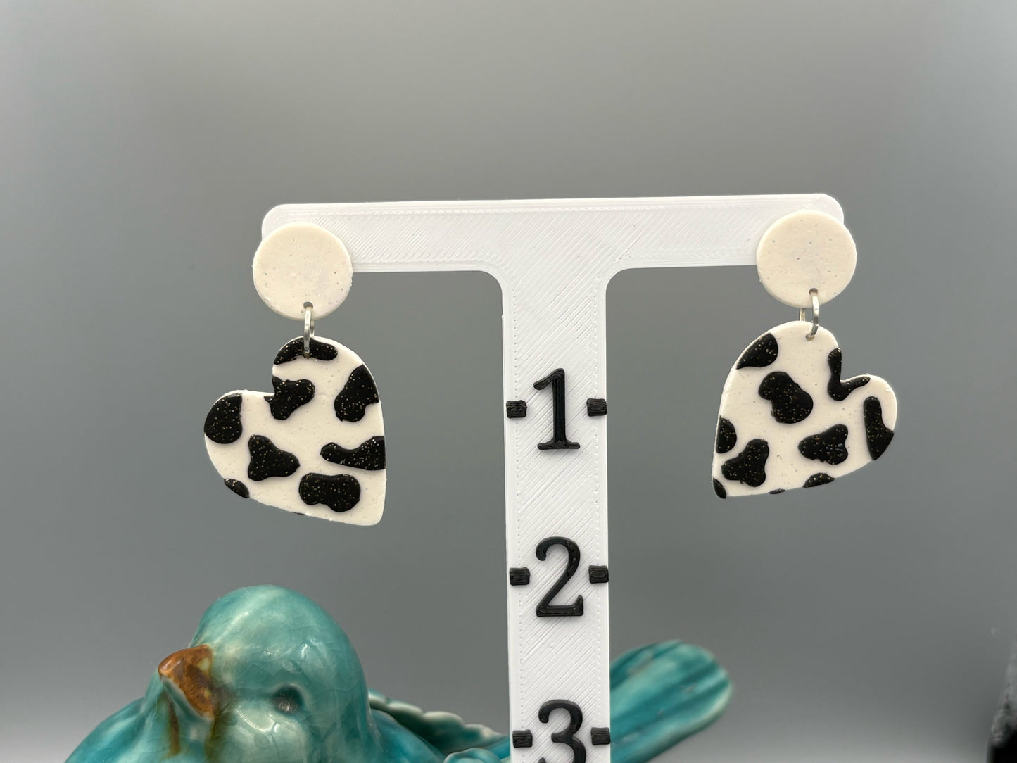 Cow Print Heart Dangle Earrings - handcrafted polymer clay earrings by Lakeside Clay