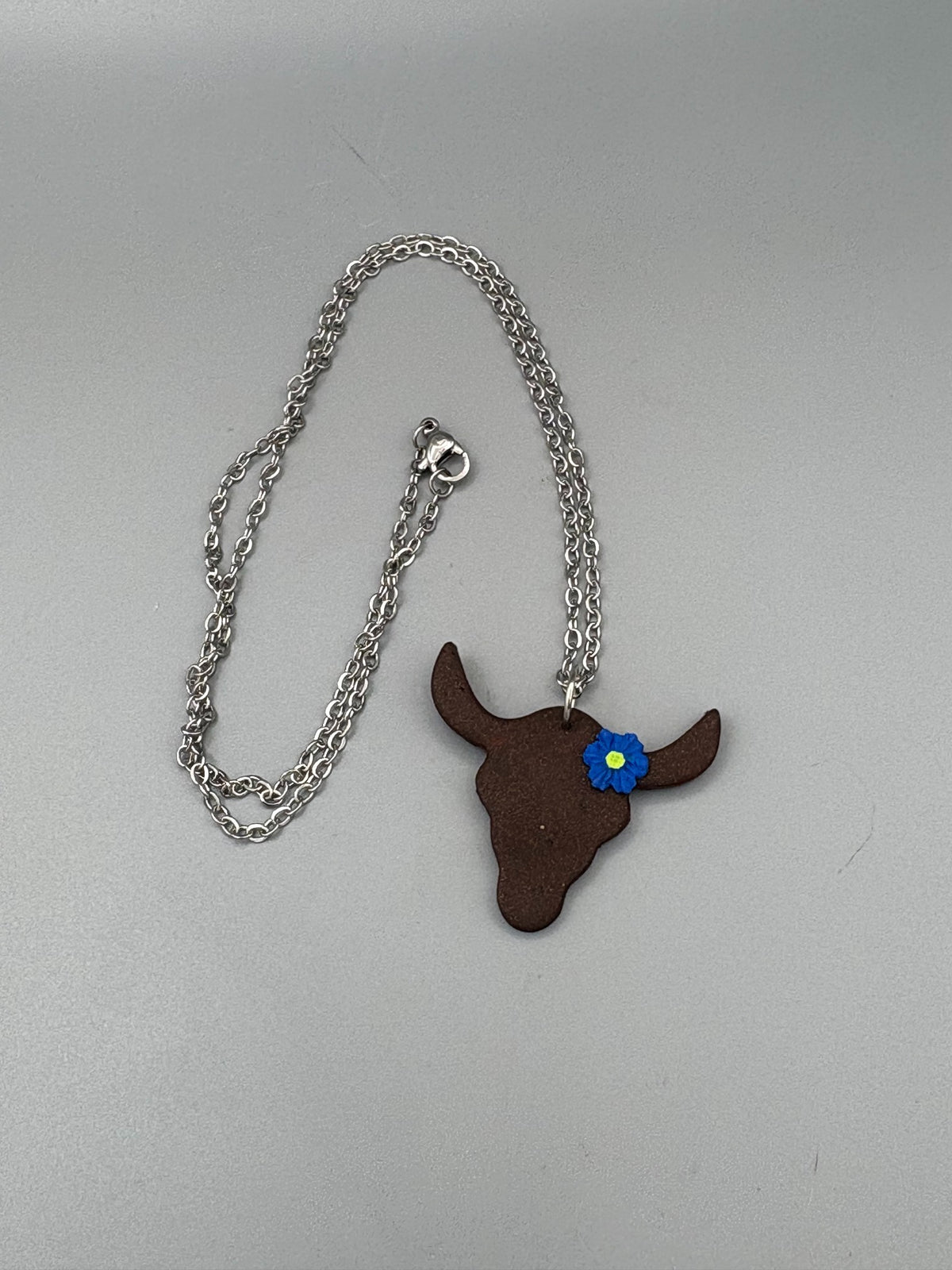 Steer with Blue Flower Necklace